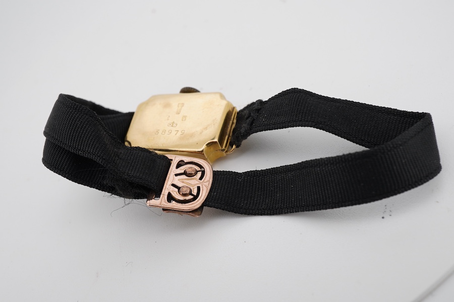 A lady's George V 18ct gold manual wind wrist watch, with Arabic dial, on a black sash strap with a 9ct buckle.